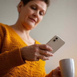 1080X1080 IGFB HealthNavigator_Sharon searching on the phone