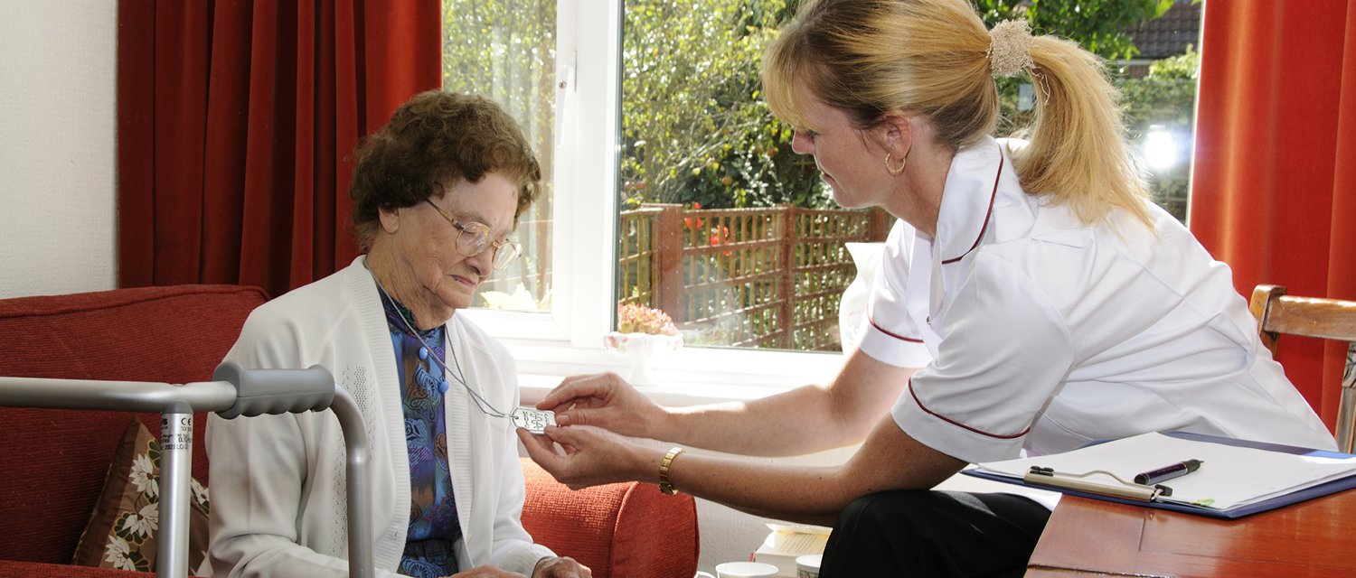 Caregiver checking card of elderly woman