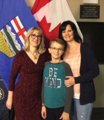 Françoise Faverjon-Fortin, CEO of MedicAlert with young male MedicAlert subscriber and his mother