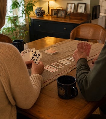 Claire Nelson and Yves, her husband, playing cards