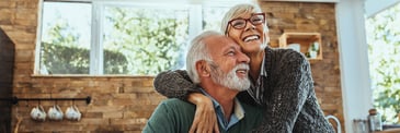 Older couple in a loving embrace at home
