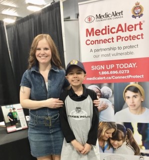 Michelle and Nolan standing in front of Connect Protect bannerevent