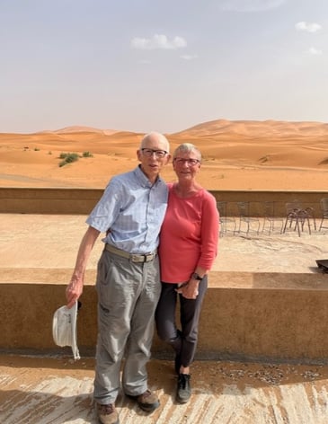 Frank and Johanna standing in front of a fence