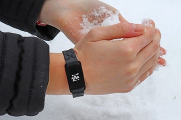 hands with a bracelet close-up with snow