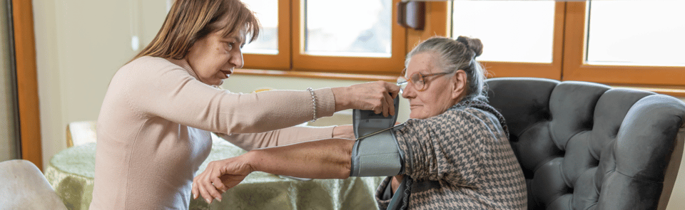 A child assisting an elderly parent.