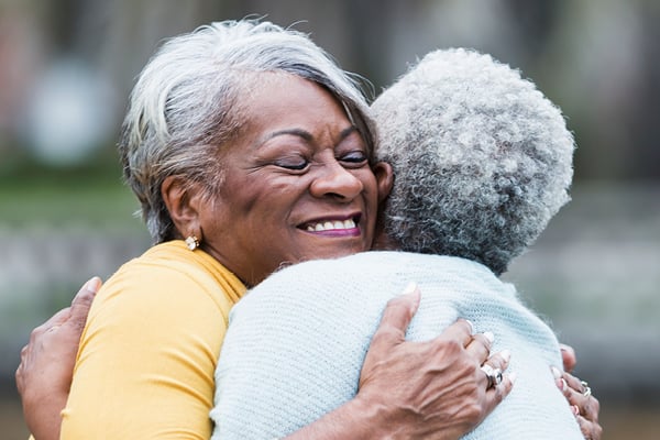elderly women hugging elderly women hugging