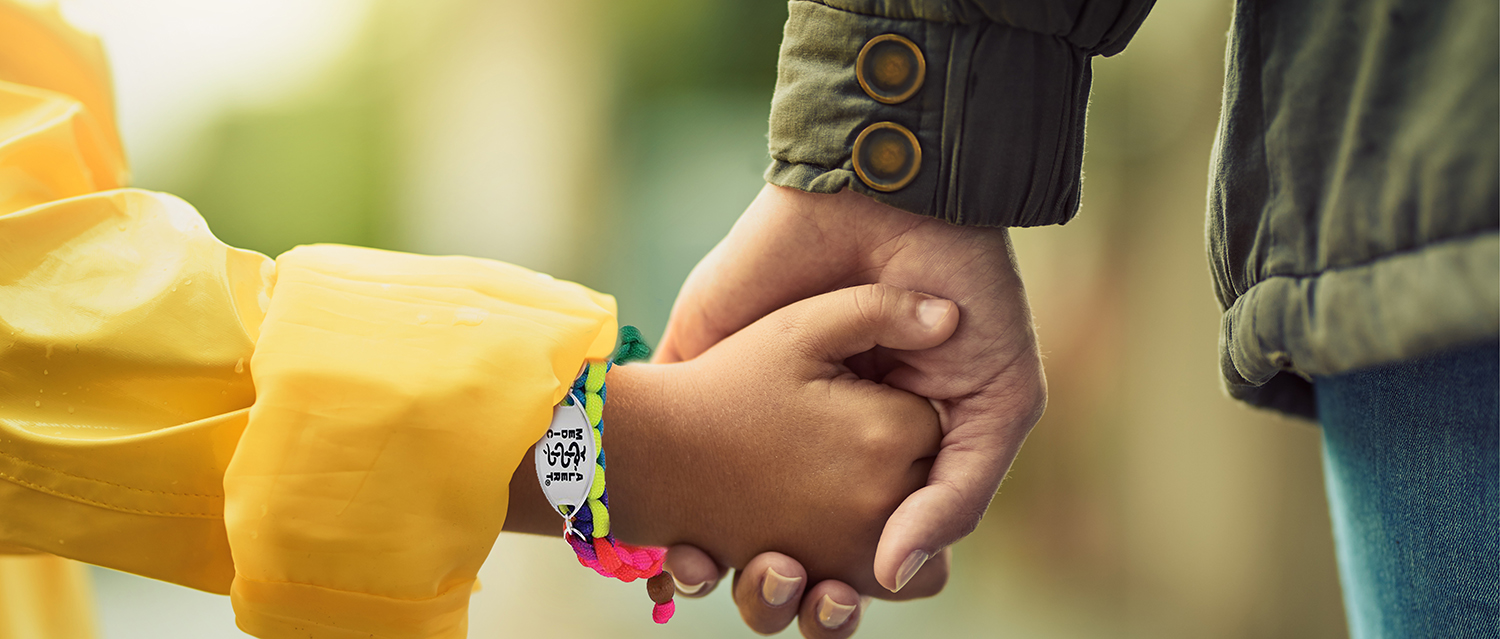 parent holding child's hand