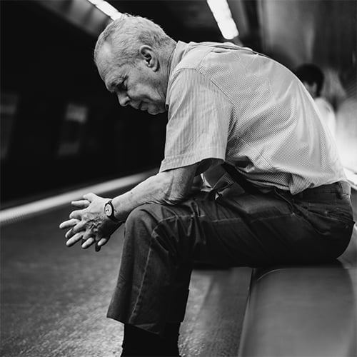 Elderly man lost and sitting