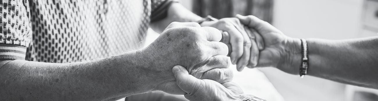 Elderly people holding hands