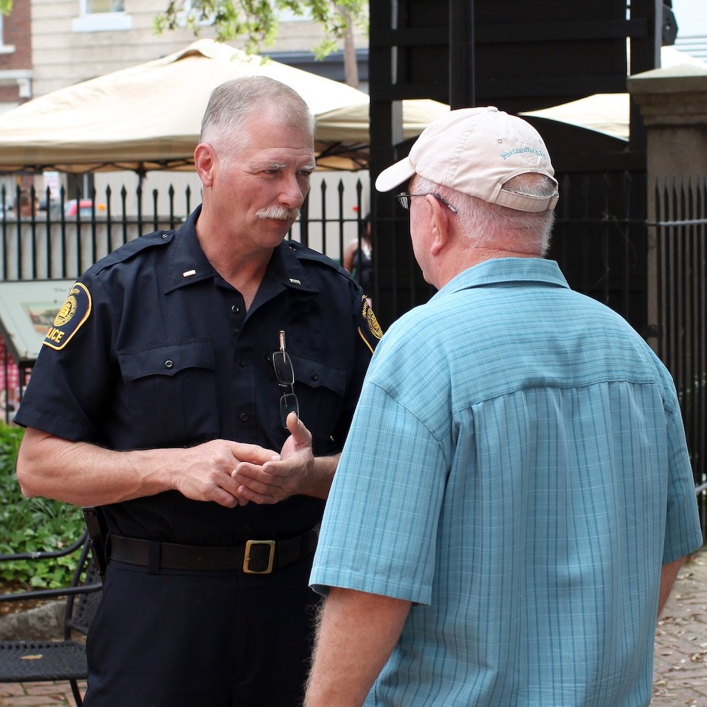 Older white man outdoors with police officer_1024x1024