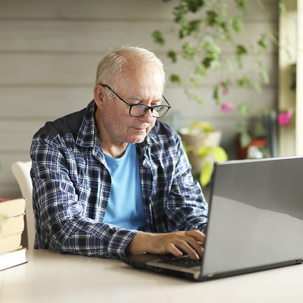 elderly man searching info on computer